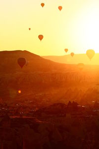 Hot air balloons against sky during sunset