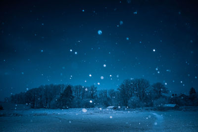 A beautiful, dark winter scenery while snowing. bright white snowflakes.