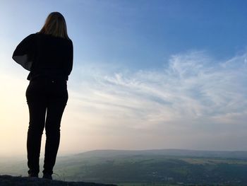 Silhouette of a woman stood on ilkley moor in yorkshire, england