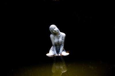 Female statue in lake