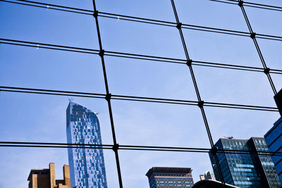 Low angle view of modern building against blue sky