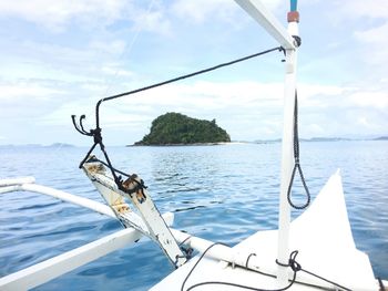 Boat sailing on sea against sky