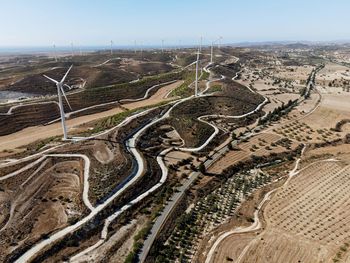 High angle view of road and windmills against clear sky