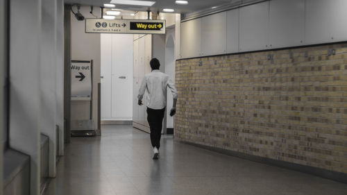 Rear view of a woman standing in corridor
