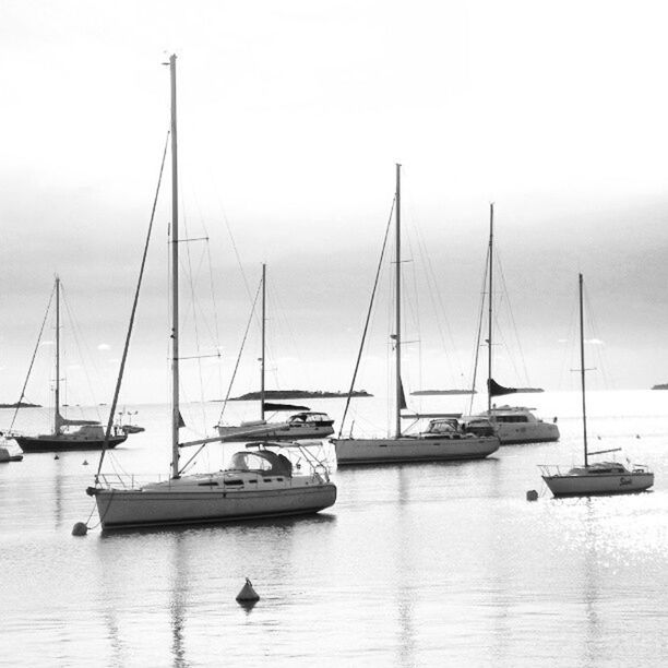 nautical vessel, transportation, boat, mode of transport, moored, water, mast, sailboat, sea, sky, waterfront, travel, harbor, reflection, nature, outdoors, tranquility, yacht, day, tranquil scene