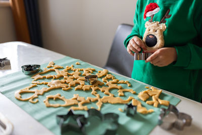 Midsection of woman holding gingerbread cookies