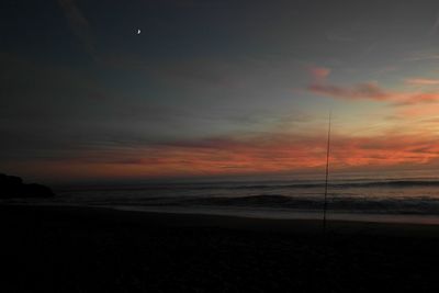 Scenic view of beach against sky during sunset