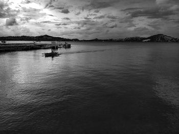 Boat sailing on lake against sky