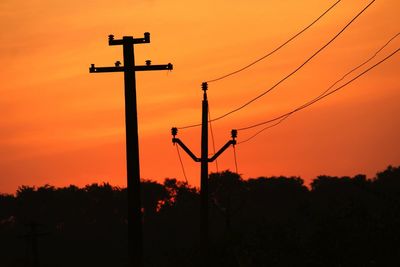 Low angle view of silhouette trees against sky during sunset