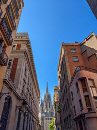 Low angle view of buildings against blue sky