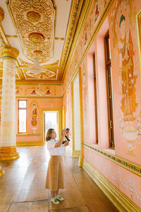 Rear view of woman in temple of thailand.