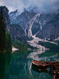 Boats on lake against mountain