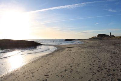 Scenic view of beach against sky during sunset