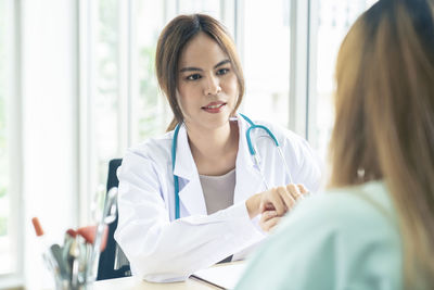 Female doctor examining patient at clinic