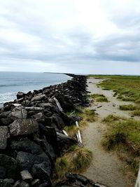 Scenic view of sea against cloudy sky