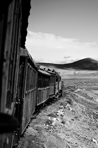 View of railroad tracks on field against sky