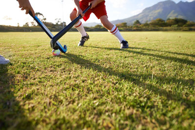 Low section of man running on field