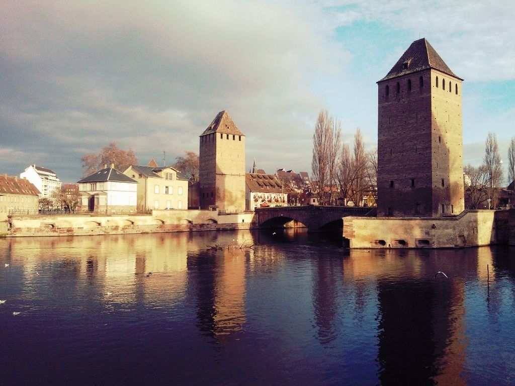 architecture, built structure, building exterior, water, sky, waterfront, river, reflection, cloud - sky, city, bridge - man made structure, cloud, cloudy, building, connection, rippled, lake, canal, outdoors, residential building