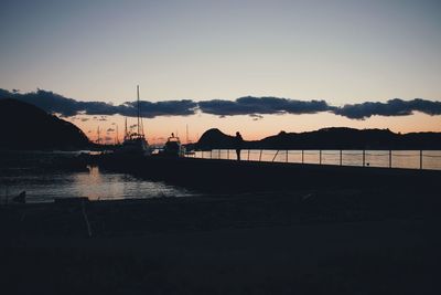 Silhouette sailboat on sea against sky during sunset