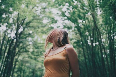 Woman standing in forest