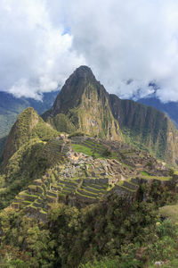 Scenic view of mountain against cloudy sky