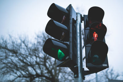 Low angle view of road signal against sky