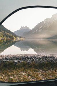 Scenic view of lake and mountains against sky