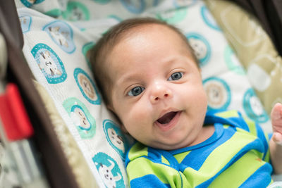 Portrait of cute baby lying on bed