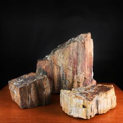 Close-up of stone on table against rock against black background