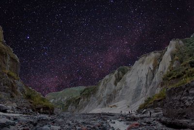 Low angle view of snowcapped mountain at night