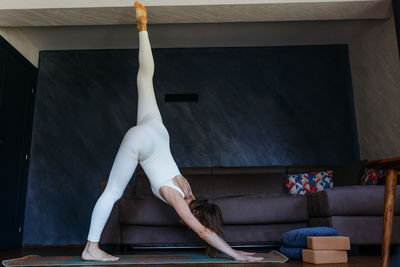 Side view of woman exercising in gym