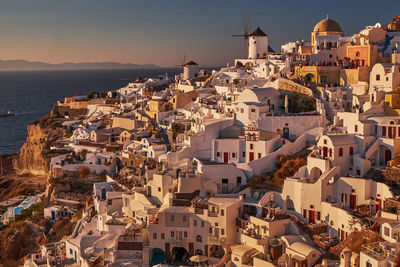 High angle view of townscape by sea against sky