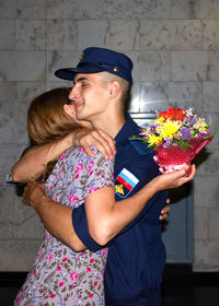 Portrait of a couple holding flower bouquet