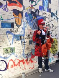 Full length of man with graffiti on wall