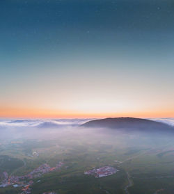 Scenic view of landscape against sky at sunset