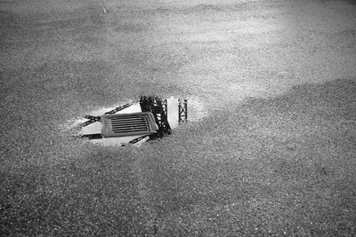 High angle view of bridge railing reflecting on puddle