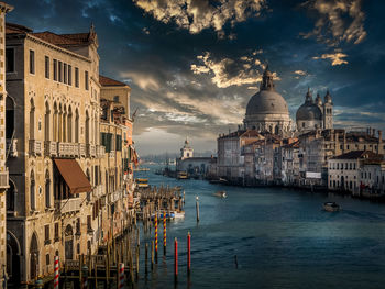 Panoramic view of buildings in city against cloudy sky