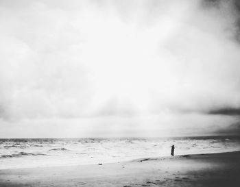 Silhouette person standing at beach