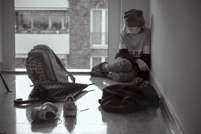 Woman sitting on floor at home