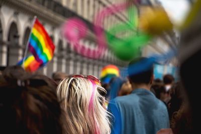 Rear view of people walking in gay pride parade