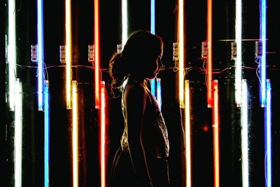 Rear view of silhouette people in dark room