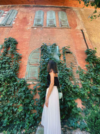 Woman standing by building