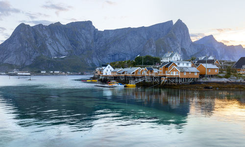 Scenic view of sea and mountains against sky