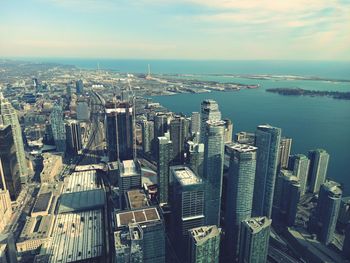 High angle view of buildings by sea against sky