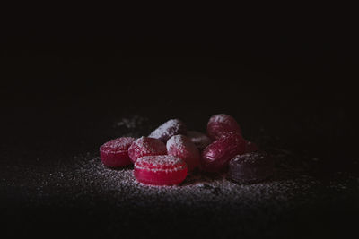 Close-up of cake on table against black background