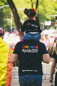 Rear view of people standing on street