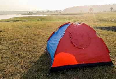 Scenic view of tent on field against sky