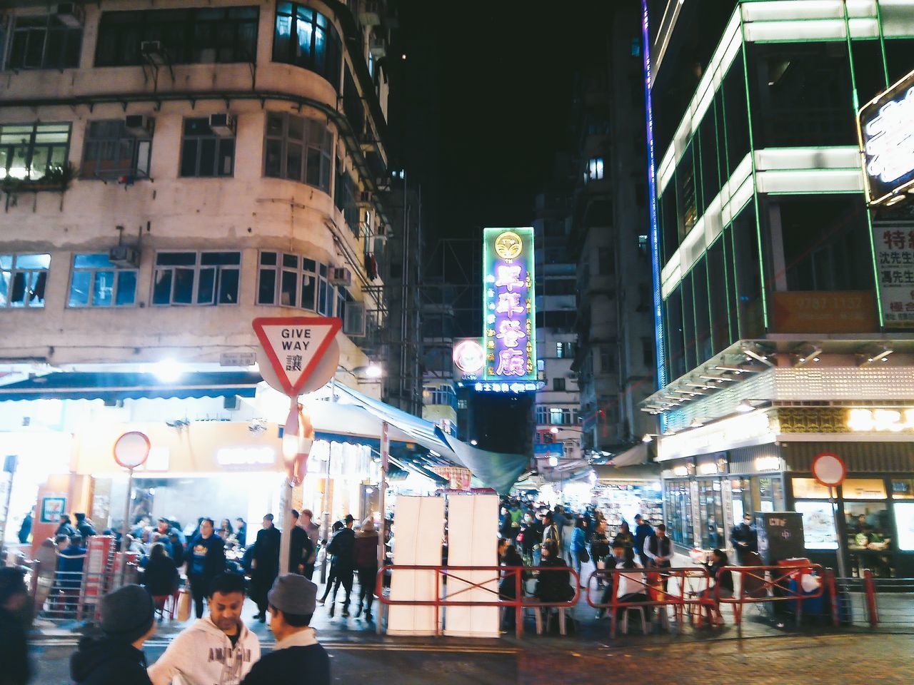 large group of people, building exterior, architecture, illuminated, city, built structure, men, crowd, night, real people, women, outdoors, people, adult