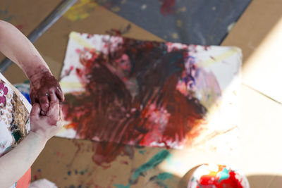 Cropped image of child painting at home