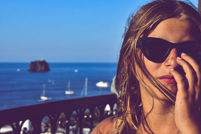 Portrait of beautiful woman against sea against sky